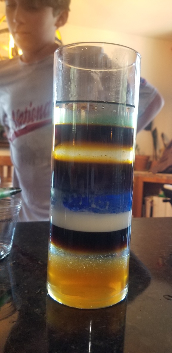 Homeschool liquid density stacking experiment showing layers.
