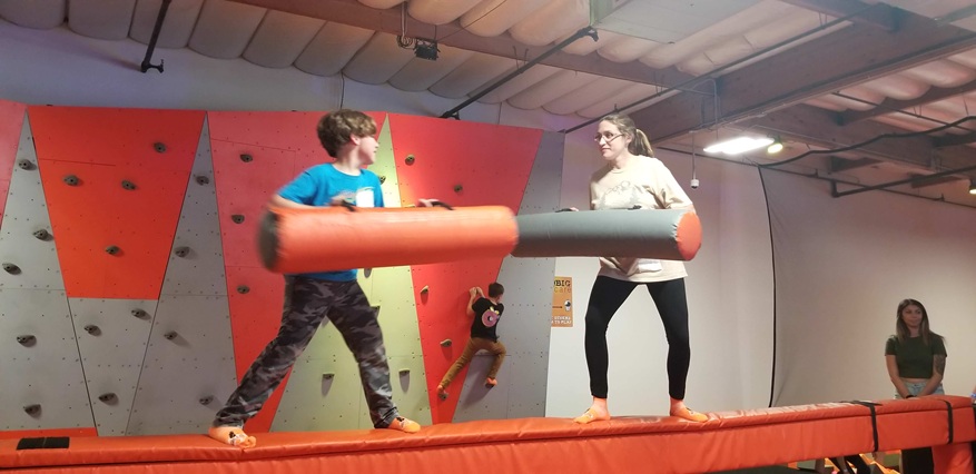 Mom and son foam pit fighting.